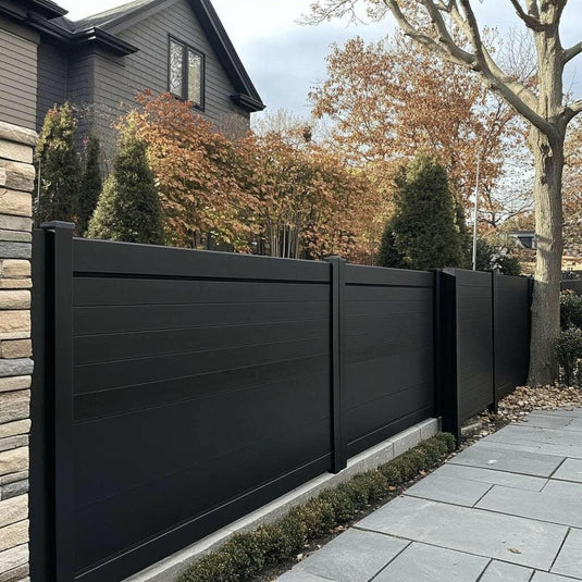Modern black aluminum privacy fence panels surrounding a restaurant patio