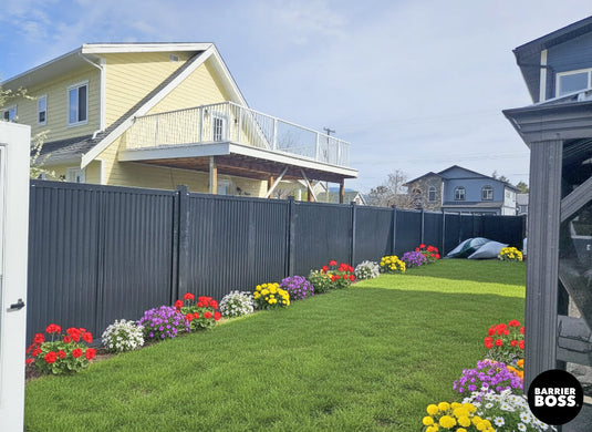 Full metal fence panels with industrial grade steel posts creating an instant upgrade in a suburban backyard.