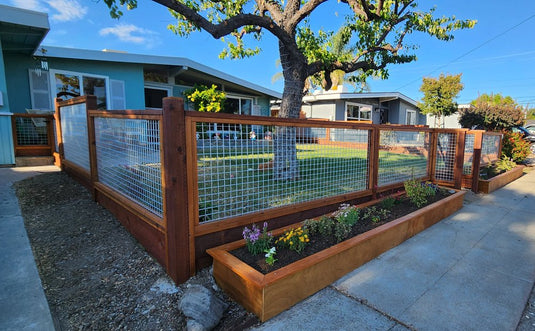 Completed BarrierBoss silver hog wire and redwood fence lining a mid-century Livermore front yard.