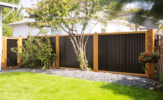 Stylish Wood and Metal Create a Modern Fence for a Contemporary Backyard.