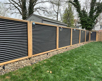 Corrugated metal and pressure treated wood enclose a backyard creating a private space.