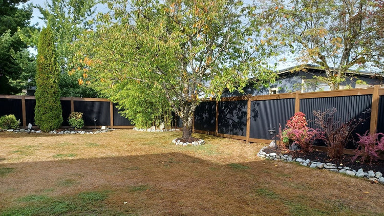 Horizontal fence of corrugated metal framed in cedar wood