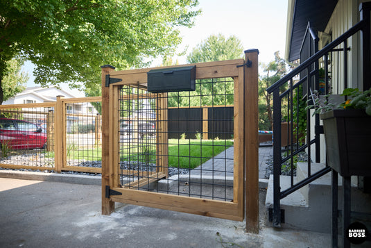Trendy hog wire gate installed with hog wire fencing on urban property.