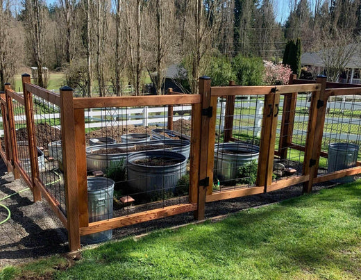 sturdy, high garden enclosure made of hog wire fence panel 