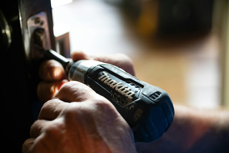 Fence Contractor Drilling A Fence - BarrierBoss