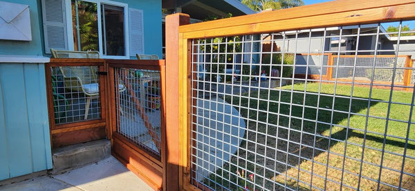 Close-up of the redwood gate frame and galvanized silver hog wire mesh on the Livermore, CA fence