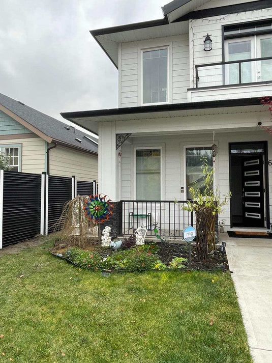 Black and white horizontal corrugated metal fence with black and white metal posts