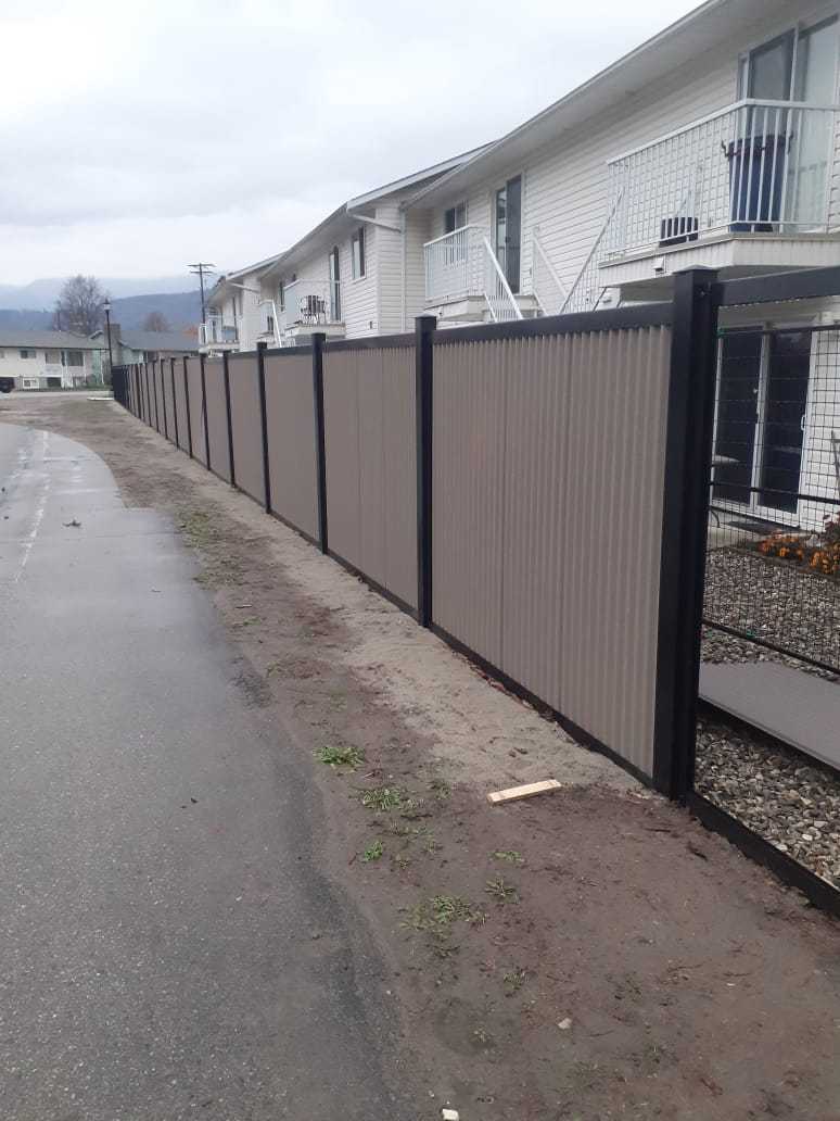 Gray Corrugated Metal Fence Panels with Steel Post Frame System - The Deep South - BarrierBoss™