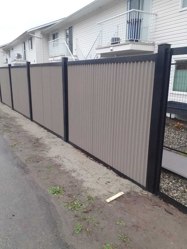Gray Corrugated Metal Fence Panels with Steel Post Frame System - The Deep South - BarrierBoss™