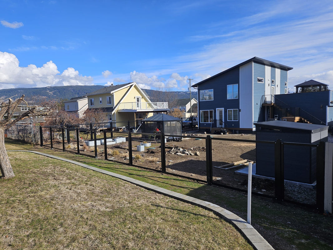 Installation of black steel posts that are part of The Deep South corrugated metal fencing.