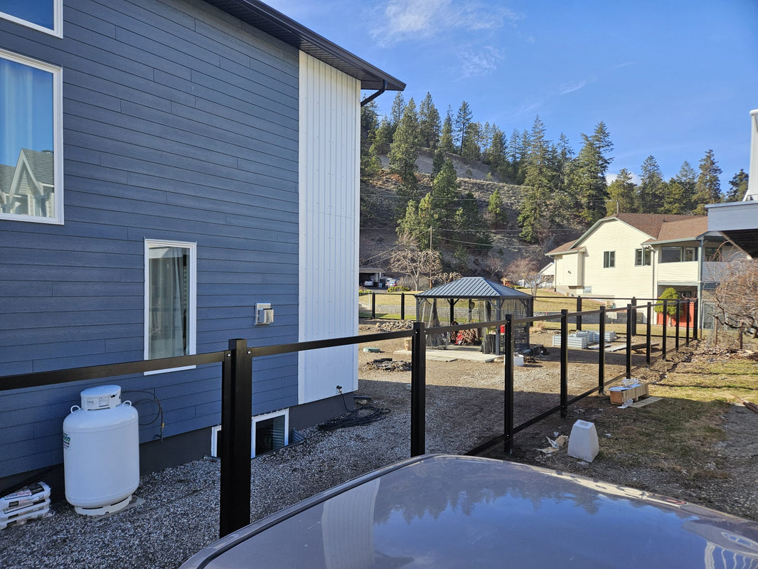 Black steel posts installed along property, waiting to be filled with corrugated metal fence sheets - Also know as The Deep South Forever Fence